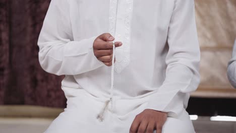 Religious-Indian-man-using-praying-beads