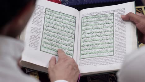 Close-Up-shot-of-Indian-people-reading-Holy-book-Quran