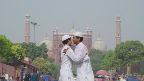 Two-Indian-muslim-men-hugging-each-other-on-Eid-festival-in-front-of-Jama-Masjid-Delhi