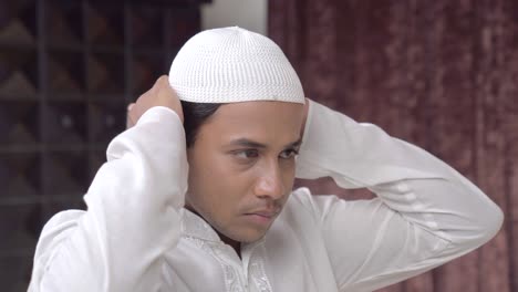 Closeup-of-Indian-muslim-man-adjusting-cap