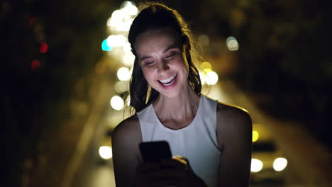 a-young-businesswoman-using-a-smartphone-at-night