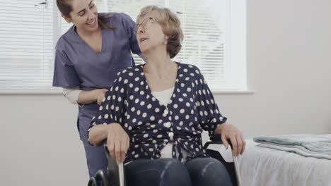 a-female-nurse-pushing-an-elderly-patient-around