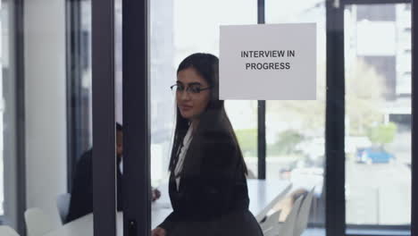 a-woman-entering-the-boardroom-for-her-interview