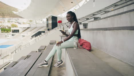 African-female-athlete-checking-notifications