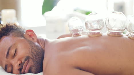 Man-at-a-spa-getting-a-cupping-massage-on-his-back