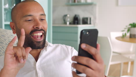 Smartphone,-video-call-and-black-man-in-living