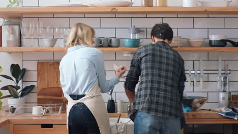 Love,-cleaning-and-kitchen-couple-play-with-dish