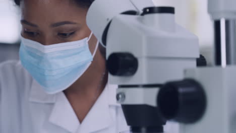 Female-scientist-using-a-microscope
