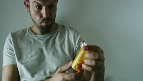 Mentally-ill-man-holding-pills-in-an-asylum