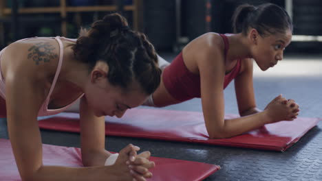 Two-fit-women-holding-plank-positions-during