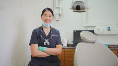 Portrait-of-a-confident-dentist-with-her-arms