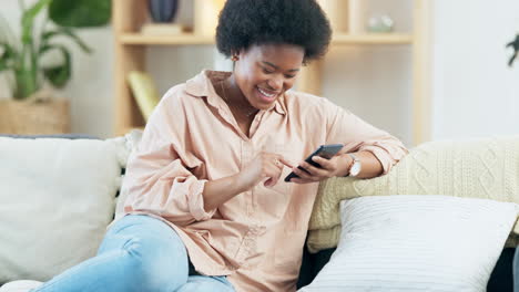 Young-woman-smiling-and-laughing-while-texting