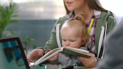 Mother-with-baby,-businesswoman-with-notebook