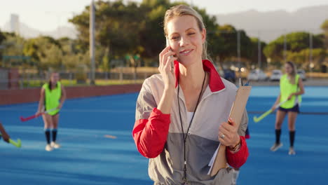 Beautiful-young-woman-hockey-coach-using-her-phone