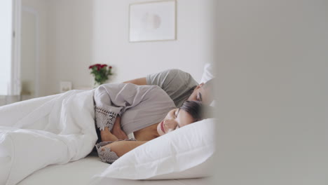 Young-couple-napping-in-a-bed-at-home