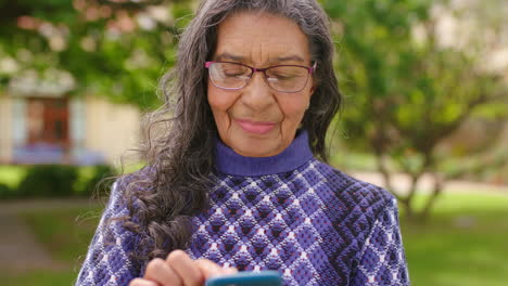 Senior-woman,-phone-or-internet-game-on-nature