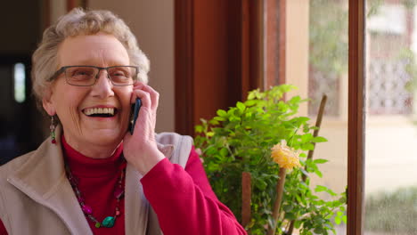 Senior-woman,-phone-call-and-laughing