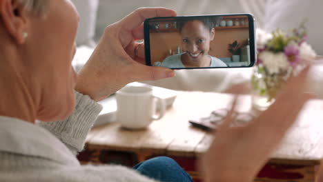 Woman-talking-video-call-phone-screen-at-home