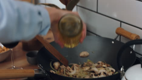 Olive-oil,-mushroom-and-couple-in-kitchen-cooking