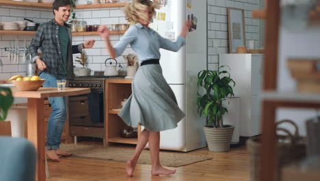 Love,-free-and-happy-couple-dancing-in-the-kitchen