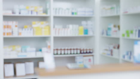 Blurred-view-of-stocked-pharmacy-shelves