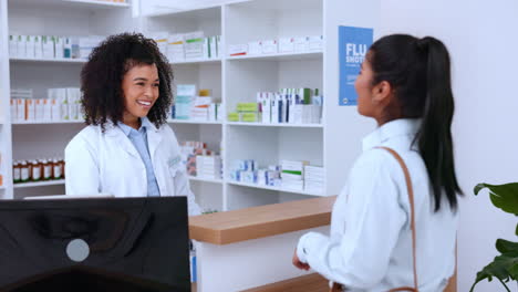 Female-pharmacist-helping-a-customer-pay