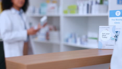 Female-pharmacist-giving-a-customer-a-medication