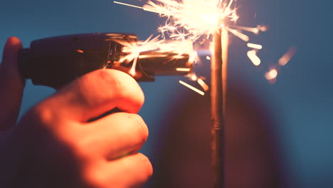 Hand-of-person-lighting-a-sparkler