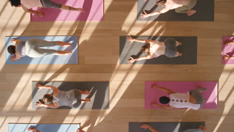 Yoga,-pilates-and-meditation-in-a-gym-with-people
