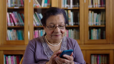 Elderly-woman-on-her-phone-in-a-library