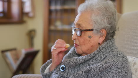 Senior-woman,-biscuit-and-eating-in-nursing-home