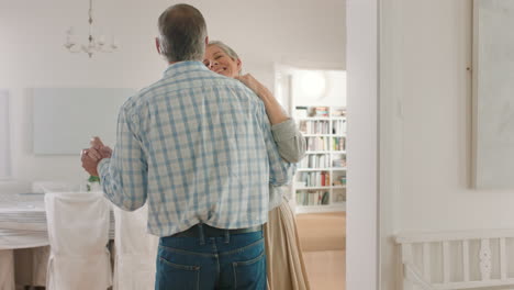 Retirement-couple-dancing-in-home-with-happiness