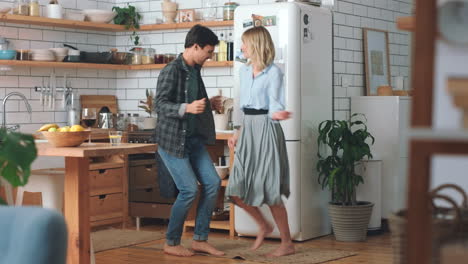 Dance,-freedom-and-love-with-couple-in-kitchen