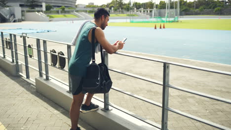 Young-male-athlete-waiting-for-his-training-coach