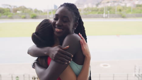 Portrait-of-female-athletes-hugging-while-training
