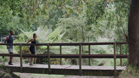 Two-athletes-running-across-a-footbridge