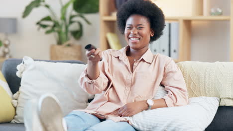 Laughing-woman-with-afro-watching-tv