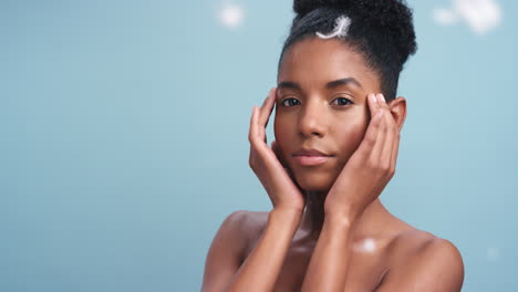Black-woman,-feathers-and-soft-skincare-model