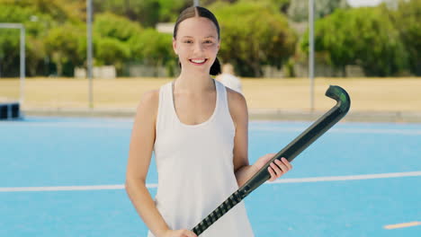 Girl-athlete-holding-hockey-equipment-looking