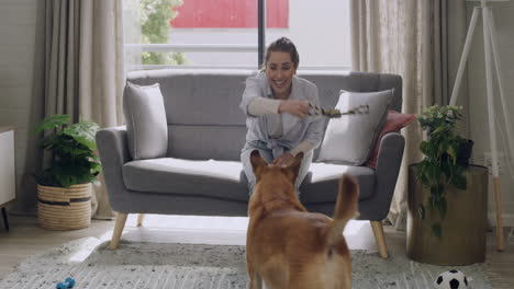 Woman-and-dog-play-together-indoors