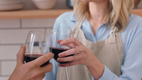 Red-wine,-cheers-and-couple-in-kitchen-cooking