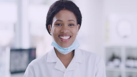 Happy-African-female-doctor-smiling-in-her-office