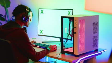 Green-screen-computer-gamer-wearing-headphones