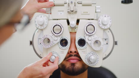 Ophthalmologist-doing-eye-test-on-male-patient