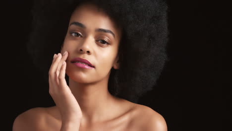 Black-woman,-afro-and-glowing-skincare-on-studio