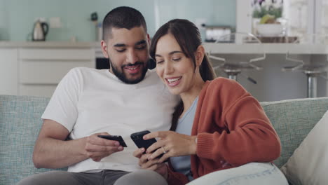 Young-cheerful-mixed-race-couple-using-a-phone