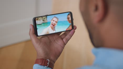 Friends-on-holiday-vacation-on-video-call-with-man