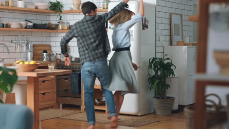Love,-happy-and-couple-dance-in-kitchen