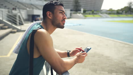 Young-athlete-using-phone-browsing-online