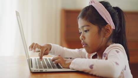 Child-learning-to-count-on-a-laptop-at-home